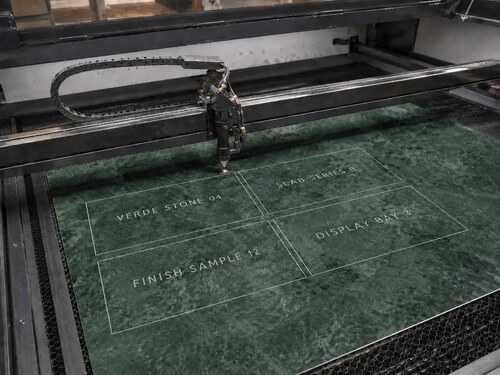 LYS-7130 thin green marble effect white core sheet processed on a realistic large CO2 laser honeycomb table